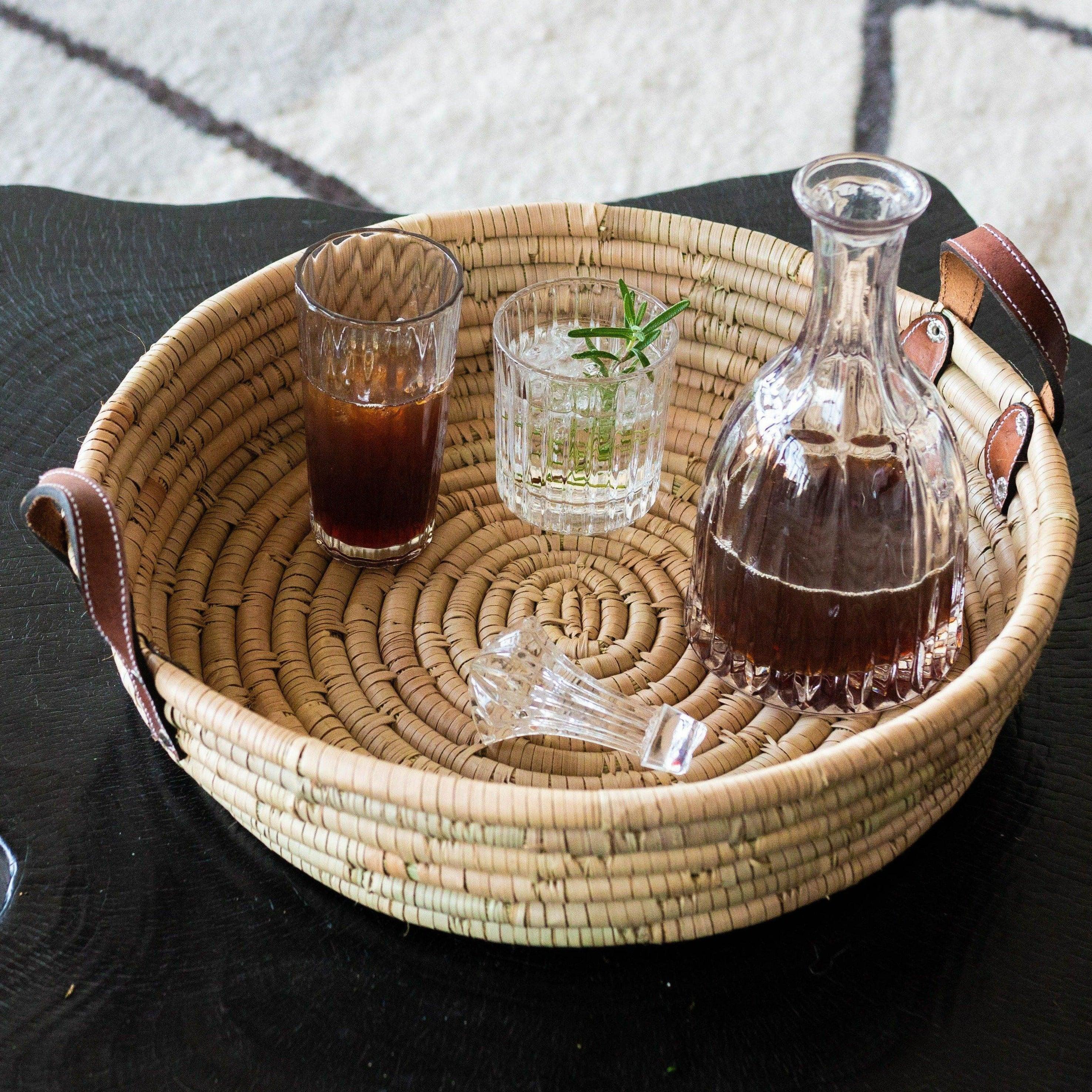 Betty Tray kanju interiors luxury vintage chic bar entertaining tray serving accent table ottoman intricate wood leather handles multifunctional functional function durable indoor outdoor handwoven basket ilala palm natural cocoa black toffee coiled organic centerpiece bowl wall decor shelf decor decorative accent hand made catch-all Zimbabwe platter canape nesting nested