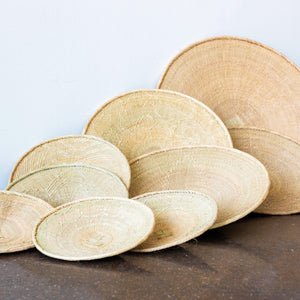 Binga Blonde Flat Baskets kanju interiors function hand woven natural grasses one of a kind unique rustic imperfect table top decor wall decor mounted organic natural fine weave baskets trays shallow bowls Zimbabwe ilala palm cream flat basket accent intricate artisan catch-all