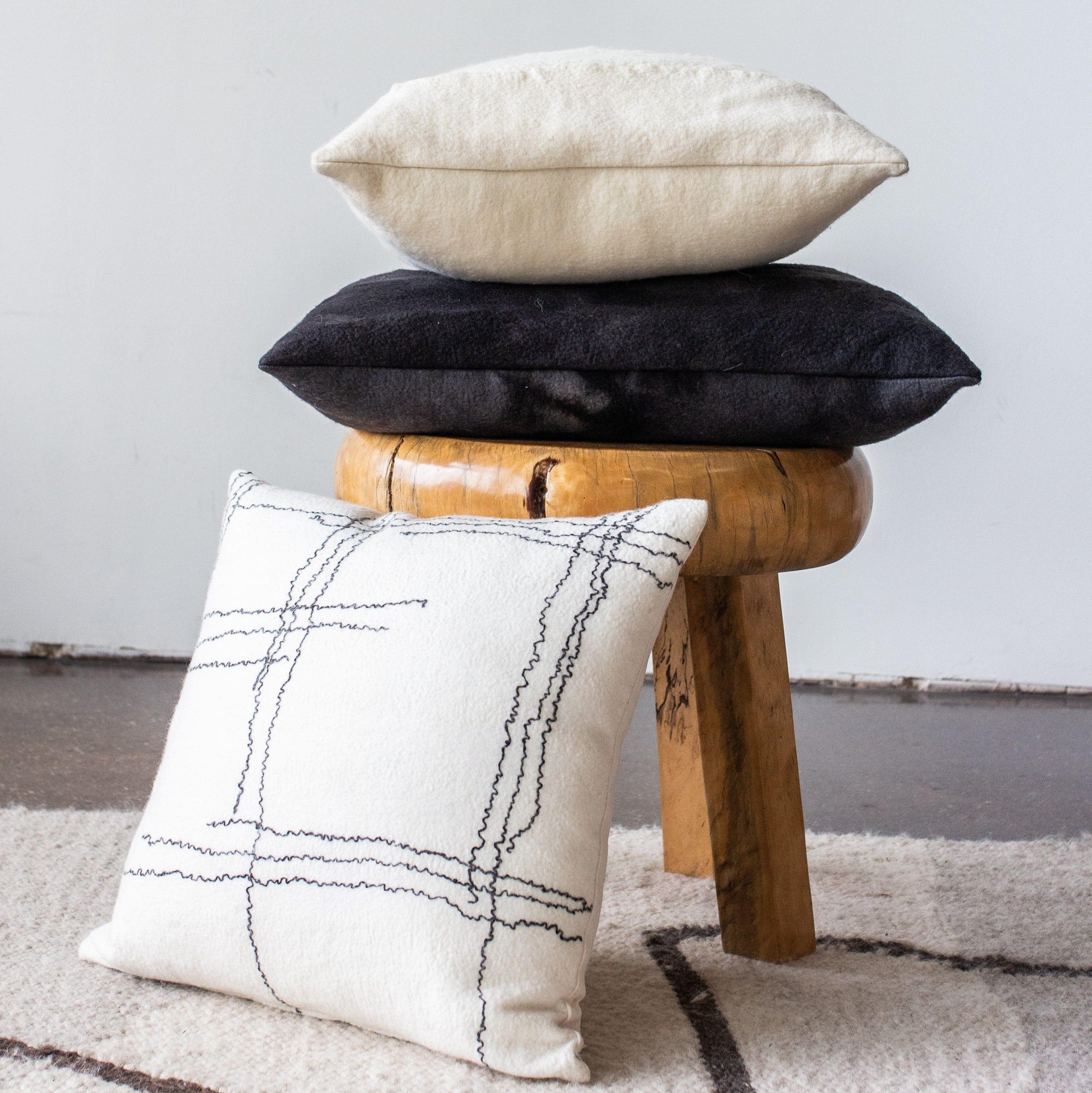 Linear Pillow kanju interiors African décor handmade natural organic color accent pillow cushion throw decorative lounge comfortable comfy unique modern contemporary stylish soft accent durable minimal couch chair bed luxury hand made home good gift hand felted felt merino wool hand dyed felting jagged layers one of a kind charcoal dark gray cream off white lines mohair yarn